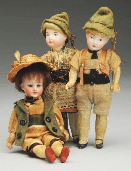 Lot of 3: German Bisque Dolls.: Unmarked but nice quality bisque head with glass inset eyes, slightly open mouth, original mohair wig, original jointed composition body with molded shoes and socks, original suit and straw hat (light