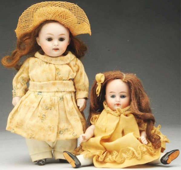 Lot of 2: All-Bisque Dolls.: Kestner 150 girl with crown label on torso (hairline crown to eye), sleeping eyes, open mouth, plaster pate, original mohair wig, vintage clothes and hat; 208 Prize Baby with label, mohair wig, sleepi