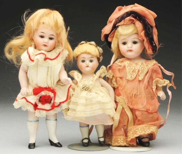 Lot of 3: German All-Bisque Dolls.: All with glass eyes and mohair wigs, jointed shoulders and hips; slender tall girl with swivel neck, Herm Steiner head probably not original to the body, nice white molded hose and heeled black slippe