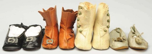 Lot of 4: Pairs of Antique Doll Shoes.: Cream heeled boots with side buttons; tan boots (one button off but included, toe ornament missing from one); black oilcloth ankle straps with toe ornaments; blue cloth with toe ornaments. Some wear.