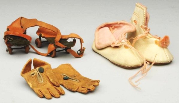 Lot of Antique Doll Accessories.: Pink leather boots with pompoms, metal and leather roller skates, tan leather fashion gloves. Very nice items! Condition (Excellent).