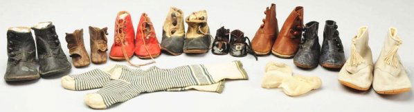 Lot of Antique Child & Doll Shoes.: Five pairs of leather child’s shoes, pair of red lace-ups with toe ornaments, 2 - 1/2" long brown leather doll boots, vintage black oilcloth shoes, blue and white striped socks. Some wear. Condition