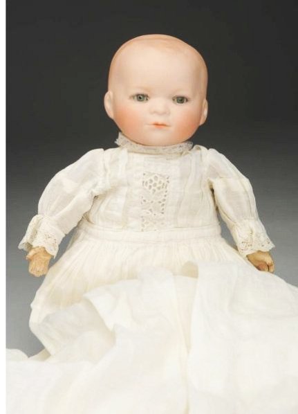 Rare German Bisque Baby Doll.: Flange neck head incised “Germany No. O" with solid dome head with curly molded hair, unusual face with upturned lips on closed mouth, sleeping eyes; original cloth body with composition hands (peel
