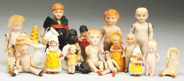 Lot of 17: Small All-Bisque Dolls.: All German. six tiny immobiles, three sitting dolls, flapper with molded hat, Kestner with yellow boots, Hertwig character, two boys with molded hair, two others. Nice instant collection of smalls! Co