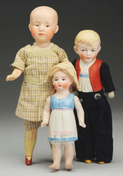 Lot of 3: German Bisque Dolls.: Gebruder Heubach 7602 pouty boy with molded hair, intaglio eyes, closed mouth on five-piece composition body with molded shoes and socks, original cotton plaid suit; all-bisque Hertwig girl with molde