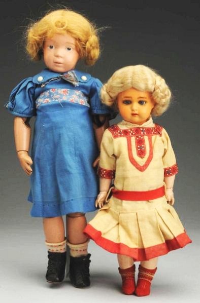 Lot of 2: Antique Dolls.: All wood Schoenhut pouty girl with Schoenhut label on back (some touch-up on face), replaced mohair wig, vintage clothing, new shoes; German K & R 406 child with celluloid head (two cracks on face), l