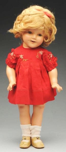 Delightful Ideal "Shirley Temple" Doll.: All composition fully marked head and body with original blonde mohair wig, lashed sleeping eyes (oiled), rosy cheeks, dimples, (light overall crazing); original tagged red pique daisy dress, slip and