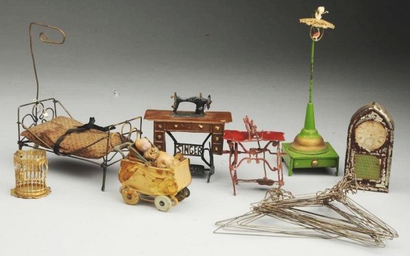 Lot of Doll House Furniture.: Wire bed with mattress, tin clock (paint loss), tin carriage marked Germany with all-bisque baby (soil, wear), lot of wire hangers, gold metal birdcage, birdcage stand, Singer tin and soft metal sewin