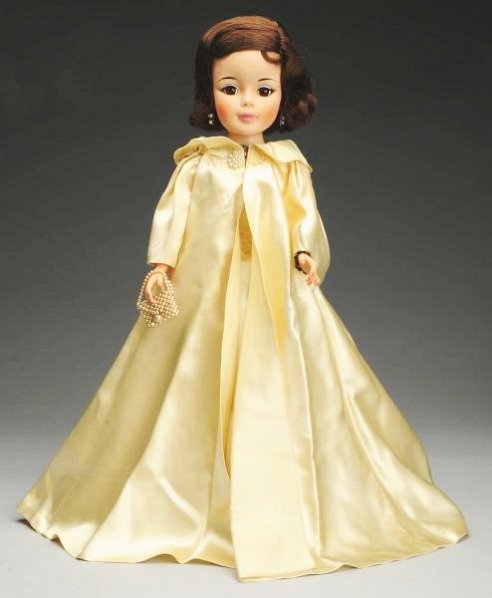 Stunning Alexander "Jacqueline" Doll.: Portrait face on jointed body, with dark hair in original set, lashed sleeping eyes with blue eyelids and liner, closed mouth, original tagged ivory satin gown (needs pressing) with metallic lace trim