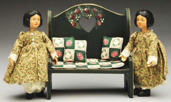 Lot of 2: Artist "Hitty" Dolls.: Carved wood dolls by Robert Raikes “Itty Bitty Hitty” #266 and 269 of an edition of 500. Along with a painted wood bench with pillows. Condition (Excellent). Size Each: 4 - 1/4" T.