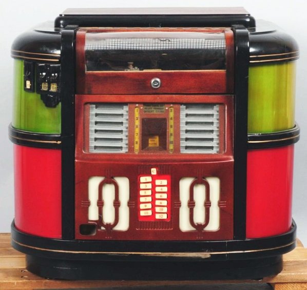 Rockola CM-39 Tabletop Jukebox.: Circa 1939. Lights and turntable spins and plays. Coin equipment is present but function beyond that is unknown. Condition (Very Good). Size 25" W.