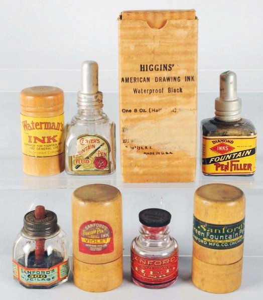 Lot of 9: Ink Bottles.: Larger Higgin's American India Ink in original shipping container, Diamond Fountain Pen Filler, Cater's Fountain Fluid Pen, Sandford, Sandford's Mucilage, old wood case for Waterman's Ink, and Sandfor