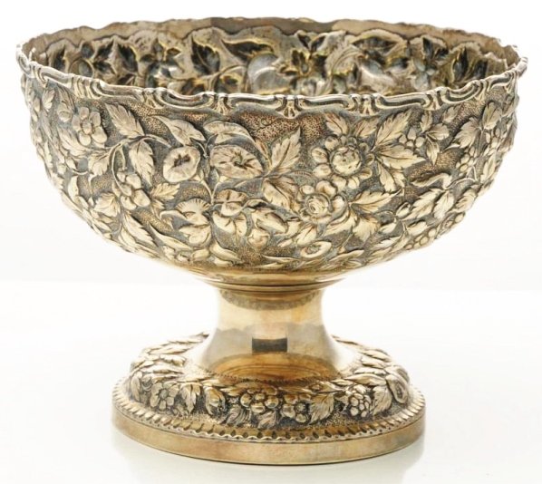 An American Silver Repoussé Center Bowl.: Andrew Ellicott Warner, Baltimore ca. 1874, circular with a cast scroll rim and two reserves on the sides, one initialed and date, and on a similarly decorated foot. Marked on outside of rim A E WARNE