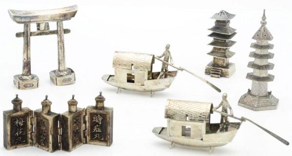 A Group of Straits Chinese Silver Condiments.: Including two pagoda salt casters, one marked STERLING; a pair of houseboats with opening roofs; a pepper caster in the form of a gate; and a set of four small flasks hinged together. Light signs of w