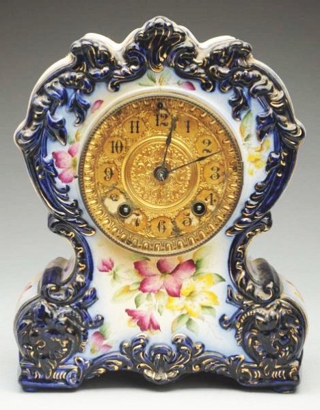 Flow Blue China Mantle Clock.: Time and strike. Dated 1881. Working condition. Some paint loss to face over the numbers "4, 5, 7, 8". Condition (Very Good - Excellent). Size 11 - 1/2" T.11 - 1/2" T.(Very Good - Excellent).