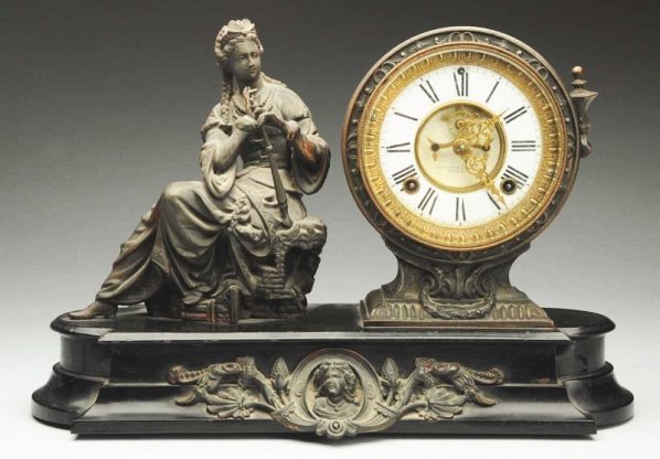 Ansonia Clock with Seated Woman.: Time and strike. Brass and porcelain dial with key and pendulum. Condition (Excellent). Size 17" L.17" L.(Excellent).