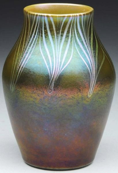 Tiffany Metallic Green Favrile Vase.: A decorated Tiffany vase from the Corona period with a pulled feather decoration on a rare green colored base glass and having a gold colored interior, circa late 1890s. Condition (Excellent). Size 5"
