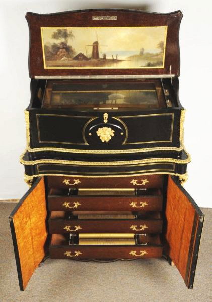 Large Interchangeable 7 Cylinder Organ Box.: With a black ebony case and an astounding amount of brass trim. This box was custom made for royalty. Organ bellows possibly need help, but otherwise in great shape. Includes key & crank. Condition (E