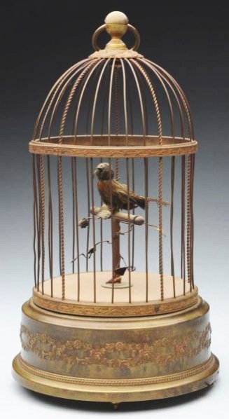 Small French Bird Cage Music Box.: Nice sound with mechanical moving bird. With some feather loss to bird. Condition (Very Good - Excellent). Size 11 - 1/2" T.11 - 1/2" T.(Very Good - Excellent).