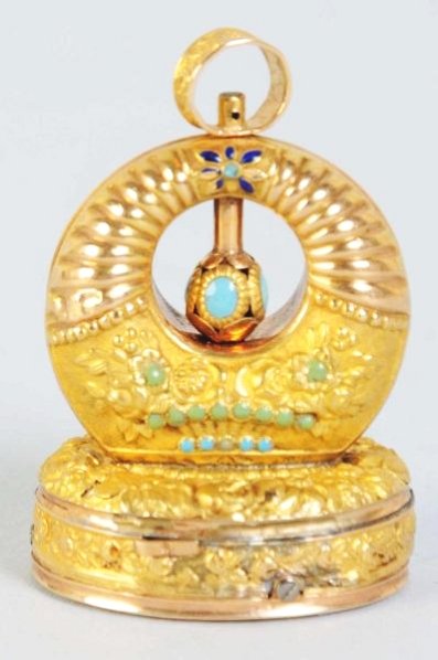 Gold "Musical Seal".: Circa 1805. Barrelette movement playing on eight stacked teeth. Case is thin repousee gold and turquoise vitreous enamel dots and flower design. Condition (Excellent). Size 1 - 3/4" T.1 - 3/4" T.(Exce