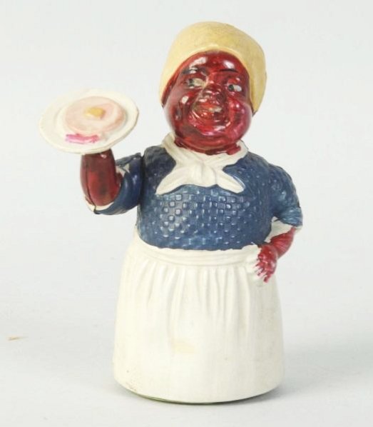 Celluloid Mammy Pancakes Windup Walker.: Depicts African American woman with apron holding plate full of food. Marked made in Japan on back. Slight crack on back between tin base and celluloid corner. Very little wear. Difficult variation to