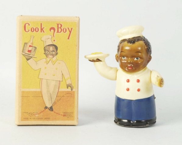 Japanese Celluloid Wind-Up Cook Boy Toy.: Includes scarce original box. Beautiful color lithography on front. Marked TN Occupied Japan. Depicts African American man holding a plate of food with chef hat on. Marked made in Occupied Japan on re