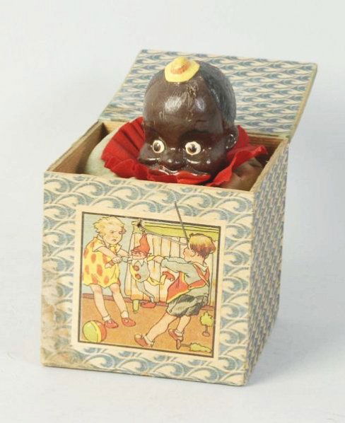 Pre-War African American Themed Jack in The Box.: Nice color paper label on front. Inside box is a African American child's head in composition which has paper mache clothing around it. When pushed down box is released it admits a squeaking noise. So