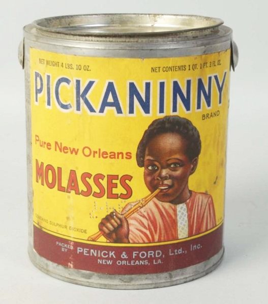 1938 Pickaninny Molasses Tin.: Empty can with no handle and paper label. A few stains and wrinkles on the label, but great color remains. Condition (Excellent). Size 6" T.
