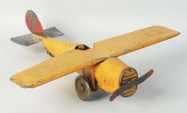 Pressed Steel American Made Airplane Toy.: Early Hill Climber type fly wall mechanisms probably made by Dayton. Possibly had decals on wings at one time. Looks to be original prop. Some scratching and wear throughout. Condition (Good - Very Go
