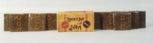 Lucky Joe Chew Tobacco & Box.: Nearly full with just one piece missing! Depicts Black youths throwing dice. Some closed tears and a razor cut on the back of box. Light wear, soiling. Lid will stand for display. Condition (Very Good