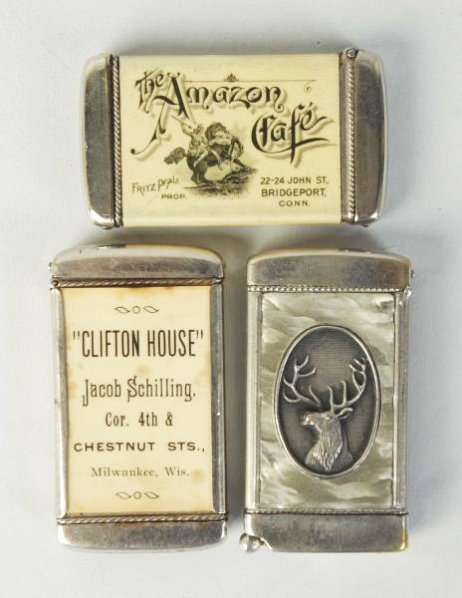 Lot of 3: Match Safes or Vestas.: Includes two celluloid advertising the Clifton House, one for the Amazon Cafe, Connecticut, and one for New Jersey of an antlered deer with cigar cutter on bottom. No damages or splits. Condition (Exc