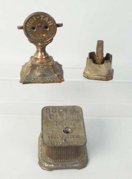 Lot of 3: Metal Items.: Includes one cigar cutter by Boltz Clymer, over-wound, one Roi-Tan Perfect For Cigar, works well, and one cast iron mortar and pestle by C.E. Potter. Condition (Excellent). Size Largest: 7 - 1/2" T.