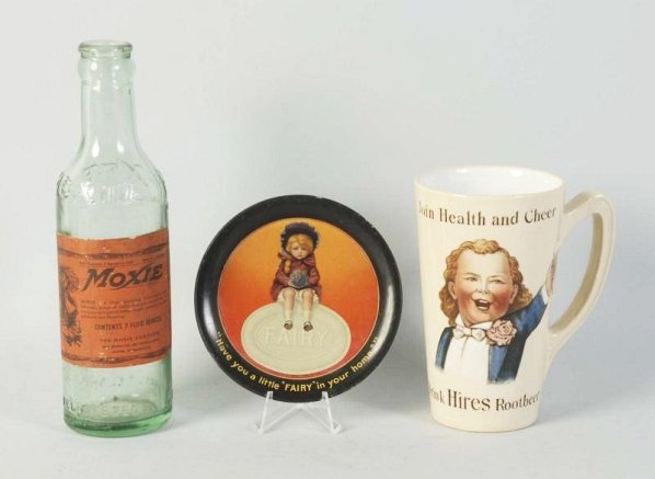 Lot of 3: Soda Related Items.: Includes a Hire's Root Beer mug, a Fairy Soap tip tray, and a Moxie soda bottle. Condition (Excellent). Size Largest: 7 - 1/2" T.