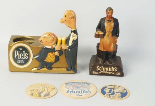 Lot of 2: Figural Beer Adv. Pieces & 3 Coasters.: 1950s metal figures with light wear. No wear on coasters. Condition (Excellent - Near Mint). Size Largest: 8 - 1/2" T.