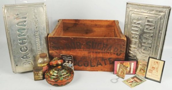 Lot of Wilbur Chocolate Advertising Items.: Wooden crate. Two covered tins. Four pamphlets glass jar, lidded broom holder. Condition (Excellent). Size 21" L.