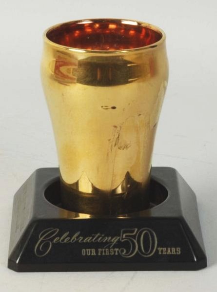 Washington Coca-Cola 50 Year Bottling Works Glass: With its stand, light wear and tape marks on back of glass. Condition (Excellent). Size 5" T.