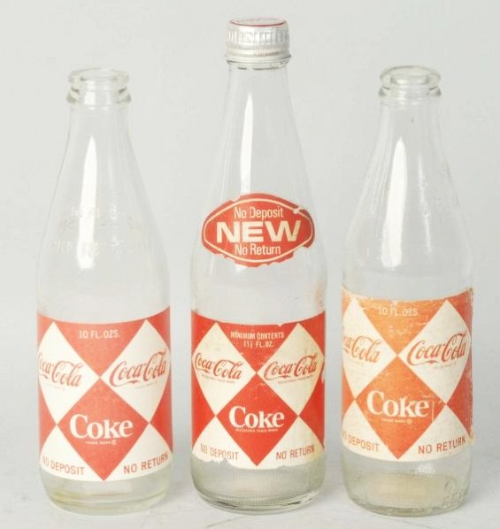 Lot of 3: 1960s Diamond Coca-Cola Paper label.: Small diamond paper Coca-Cola label bottles. Two 10 oz. and one 11 Â½ oz . screw cap. Light to moderate label soiling or wear. Condition (Very Good - Excellent). Size Largest: 8 - 3/4" T.