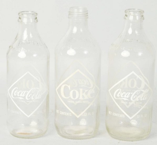 Lot of 3: 1960s Coca-Cola Diamond ACL Bottles.: 10 and 13 oz. One is a screw top with mild stains. Little to no wear on the others. Condition (Excellent - Near Mint). Size 7 - 1/2" T.