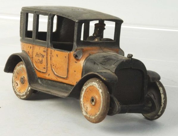 Cast Iron Arcade Yellow Cab.: Disc wheels. Embossed original driver. Rubber stamped Yellow Cab on rear doors. Original meshed screen. Embossed Arcade on inside. Some paint loss and wear to three wheels fourth wheels is missing and