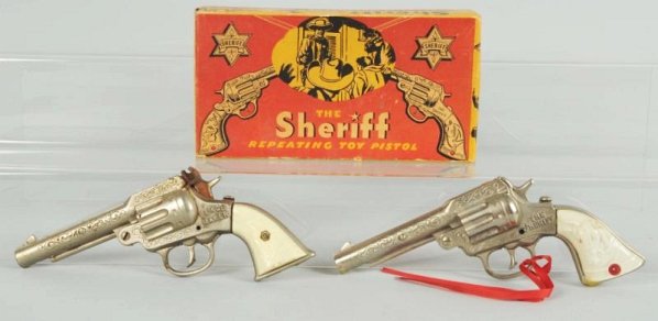 Lot of 2: J&E Stevens Toy Cap Guns.: One in original box marked "The Sheriff". Second is Peace Maker. Sheriff has some wax and minor damage to grip. Box has some edge wear. Piece maker has some oxidation and rust to hammer both working.