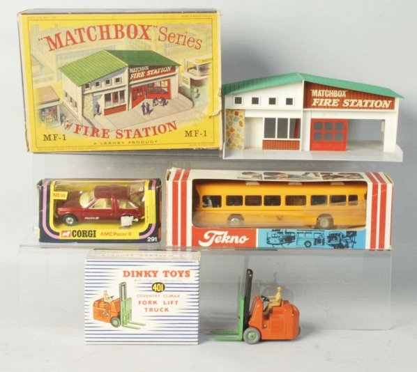 Lot of 4: Match Box Dinky & Tekno Toy Cars.: All have original boxes. No.401 Dinky Forklift. No.291 Corgy pacer automobile. a No.MF-1 Matchbox firehouse missing vehicles and a No.851 Tekno bus. Plastic ripped on front of Tekno bus, matchbox box 
