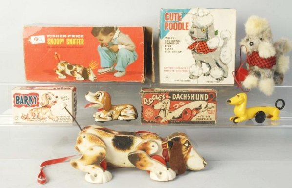 Lot of 4: Boxed Mechanical Toy Dogs.: American and Japanese made. Marx Dachsund, a Japanese tin litho barky battery operated Yonesowa, Cute poodle and a fisher price Snoopy Sniffer All in original boxes some have tearing and missing flaps
