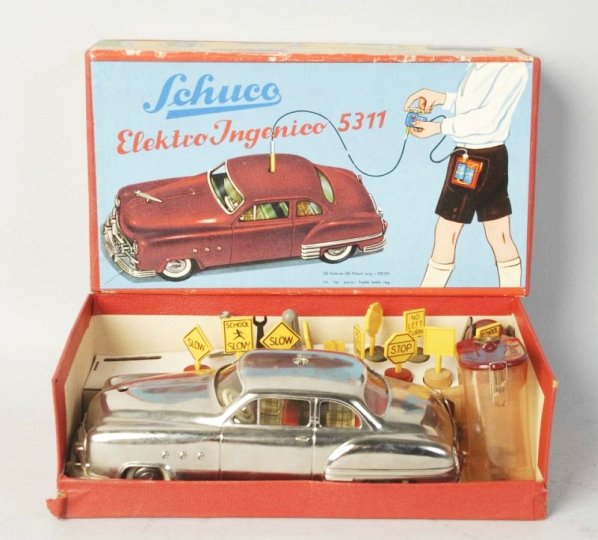 Schuco Remote 5311 Car in Box.: Original box. Scarcer silver model. Has insert with key plastic road signs and battery holder also remote control also German Shuco. Condition (Excellent). Size 10 -1/2" L.