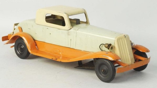 Pressed Steel Wind-up Car.: Girard wind-up deluxe automobile. Battery operated headlights, has original rear tailgate. Some scratching and wear especially to fenders and roof. Condition (Very Good). Size 14 - 1/2" L.