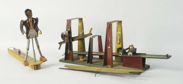Lot of 2: Vintage Tin Mechanical Toys.: One is an over/under toy probably made by Wolverine with the original car. Second is a African American man lever activated dancer. Which is probably Canadian made. Condition (Very Good). Size Largest