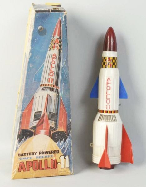 Plastic Japanese Apollo-11 in Box.: Battery Operated. Made by TN Japan whose original box does have some creasing and wear. Condition (Very Good). Size 13" T.