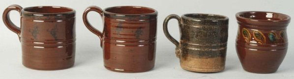 Lot of 4: Ned Foltz Redware Pottery.: Includes three handled mugs and one vase. Two with spongeware and one with slip ware decoration. No damage or repair. Condition (Excellent). Size Largest: 4 - 1/2" L.