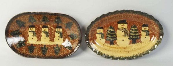 Lot of 2: Ned Foltz Redware Pottery.: Oval platters with snowman and Christmas tree. No damage or repair. Condition (Excellent). Size Largest: 12 - 1/2" L.