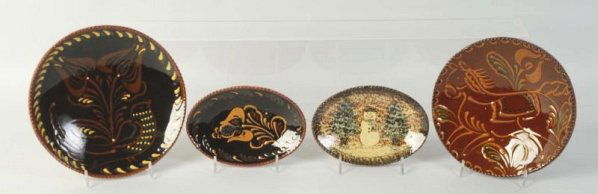 Lot of 4: Ned Foltz Redware Pottery Plates.: Oval with horse and second with floral. Oval plate with snowman. and floral. No damage or repair. Condition (Excellent). Size Largest: 8" Dia.