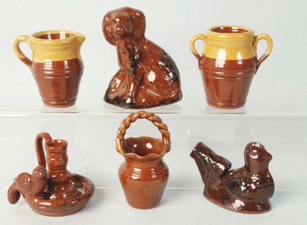 Lot of 6: Ned Foltz Redware Pottery Pieces.: Sitting dog, pie bird chicken, handled bartet candle holder with birds and two handled pot and pitcher. Condition (Excellent). Size Largest: 4" T.